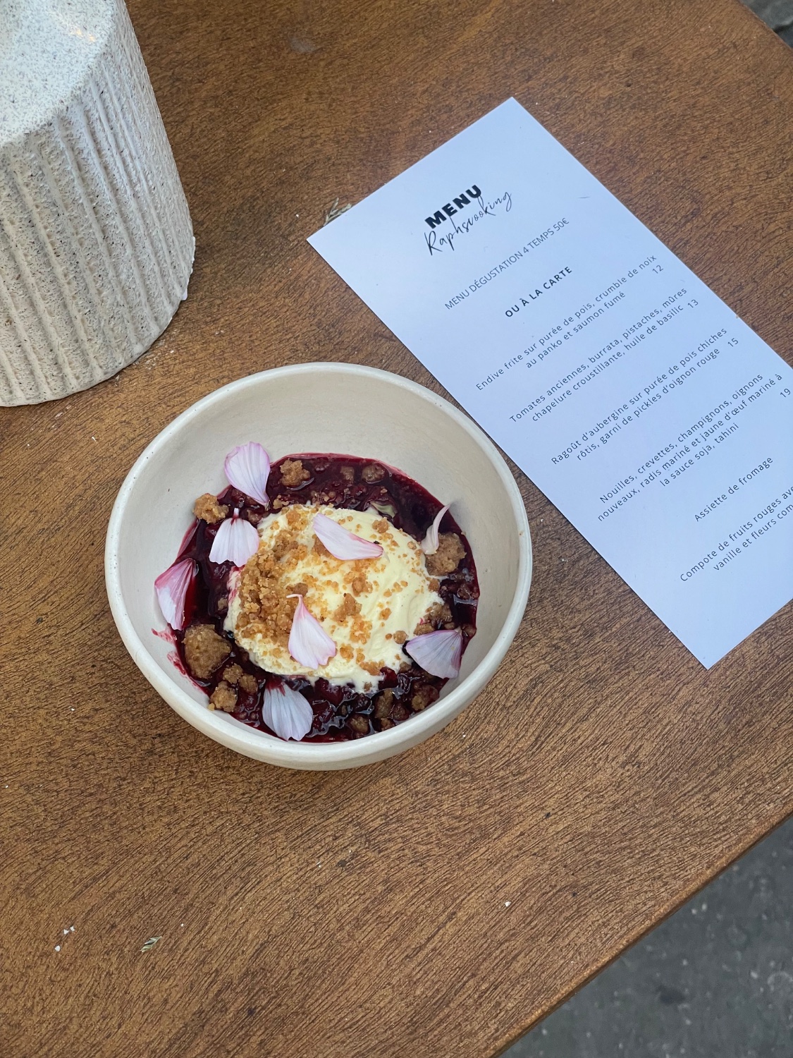 Red fruit compote with cream and flowers